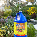 Fertilizer bottle in front of lively plants